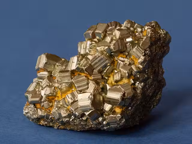 Close-up of fools gold (iron pyrite) crystals showing metallic yellow lustre.