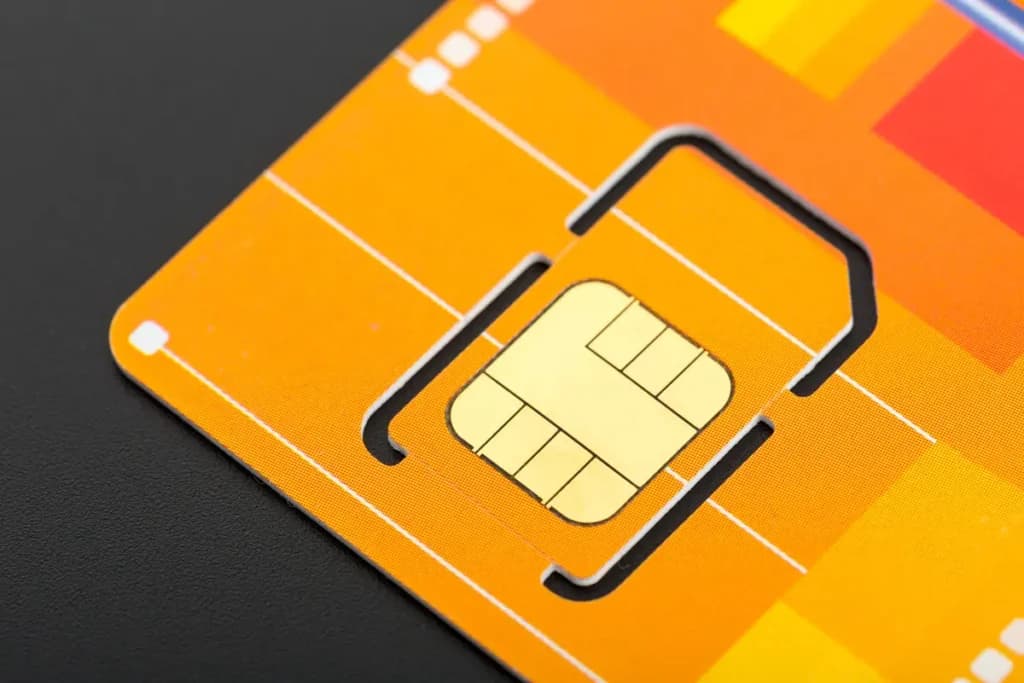 Close-up of a SIM card with a visible gold contact chip, illustrating what gold is used for in electronics due to its excellent conductivity and resistance to corrosion.