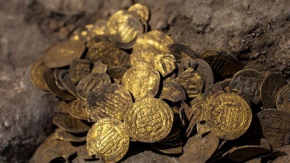 Ancient gold coins over 1,000 years old showing minimal tarnish, illustrating how long gold lasts over time.