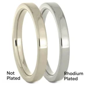 Side-by-side comparison of two white gold rings: one unplated with a warmer tone, and one rhodium plated with a bright, silvery finish—illustrating plated white gold vs unplated white gold.