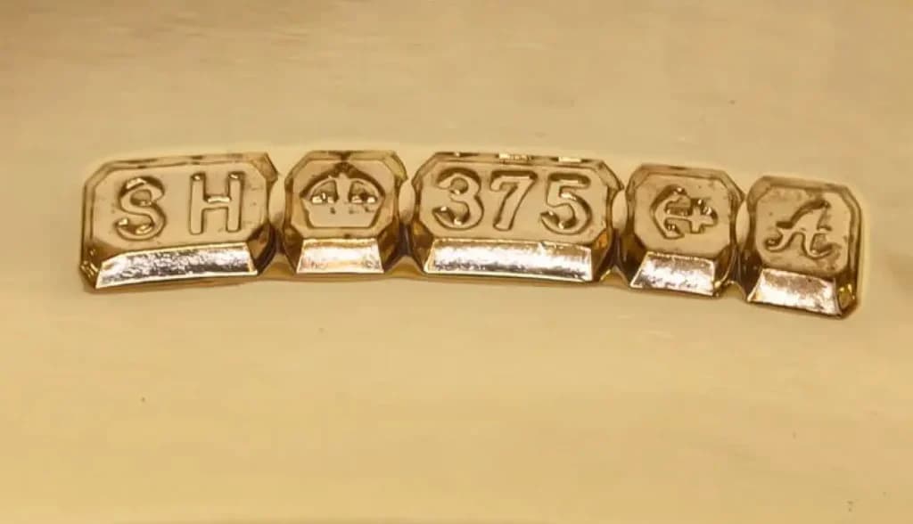 Close-up of 9ct gold hallmarks showing the 375 stamp on 9ct gold with Assay Office and maker’s marks.
