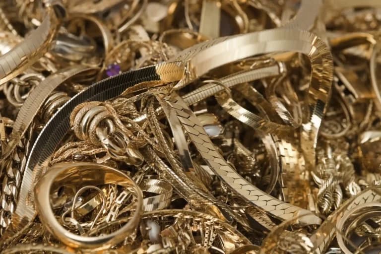 Pile of scrap gold jewellery, illustrating the value hidden in broken or unwanted gold items and supporting the question, "Is scrap gold worth anything?"