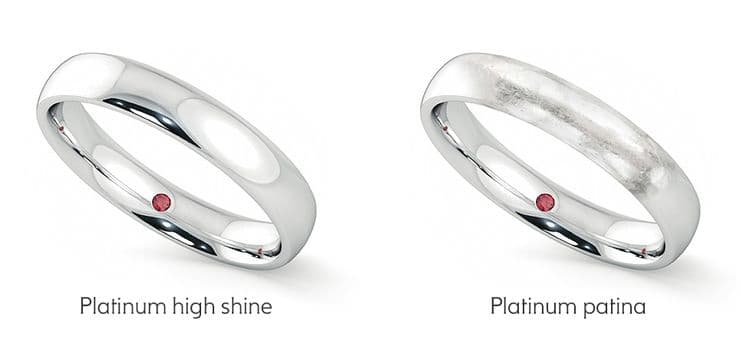 Two platinum rings side by side; the ring on the right has developed a matte patina from wear, while the ring on the left has been recently polished to a high shine. The patina gives the right ring a slightly dull, frosted look compared to the reflective finish of the polished ring.