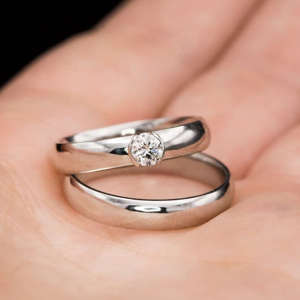 Close-up of two platinum rings showing the distinctive platinum colour and lustrous finish typical of high-quality platinum jewellery.