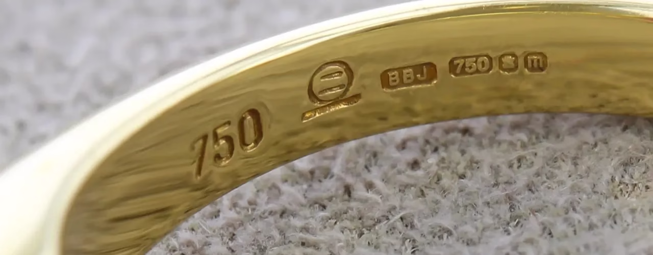 Close-up of a 750 hallmark inside a gold ring, used to identify 18ct gold for customers looking to sell 18ct gold in the UK.