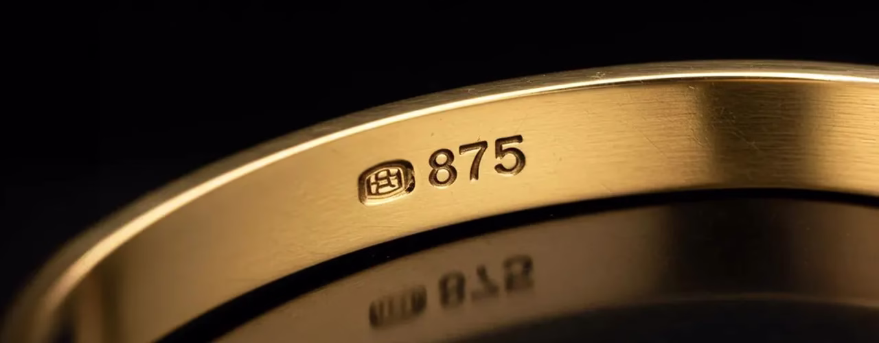 Close-up of a gold ring stamped with the 875 hallmark, representing 21ct gold purity, ideal for customers looking to sell 21ct gold.