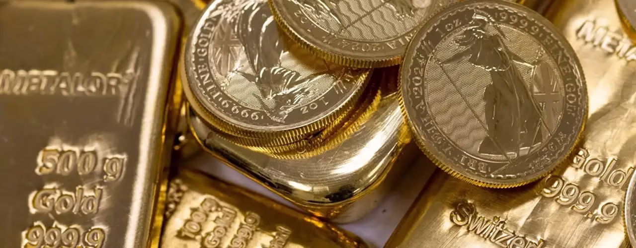 Hero image of 24ct gold bars and gold coins for those looking to sell 24ct gold at its highest market value.
