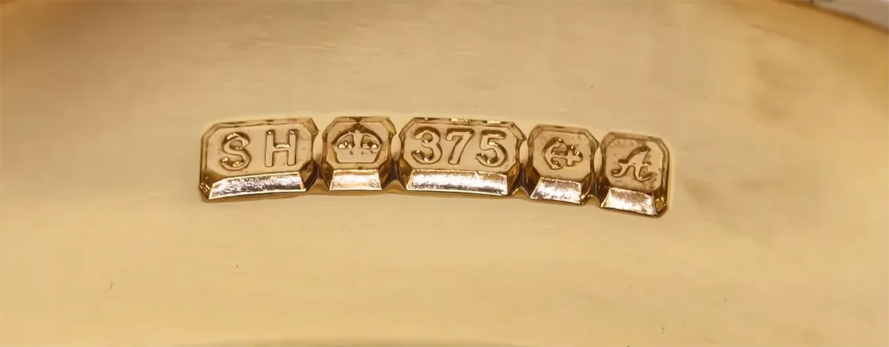 Close-up of a 375 hallmark on jewellery, indicating 9ct gold purity — used to determine accurate 9ct gold price when you sell 9ct gold online.