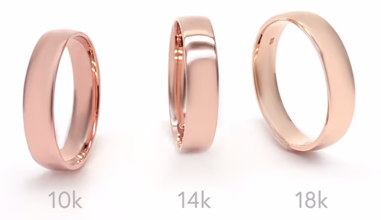 Three different types of rose gold rings in 10k, 14k, and 18k showing how colour varies by karat.