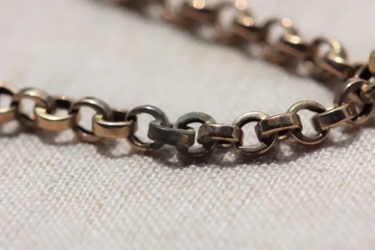 Tarnish on gold chain showing darkened links, illustrating why many people search how to clean gold chain at home.