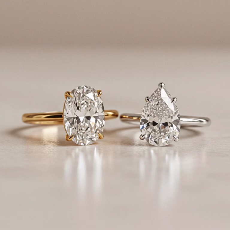 Oval and pear-cut diamond rings showing the difference between yellow gold and white gold rings.