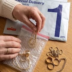 Royal Mail Special Delivery pack being handed over the counter at the post office.